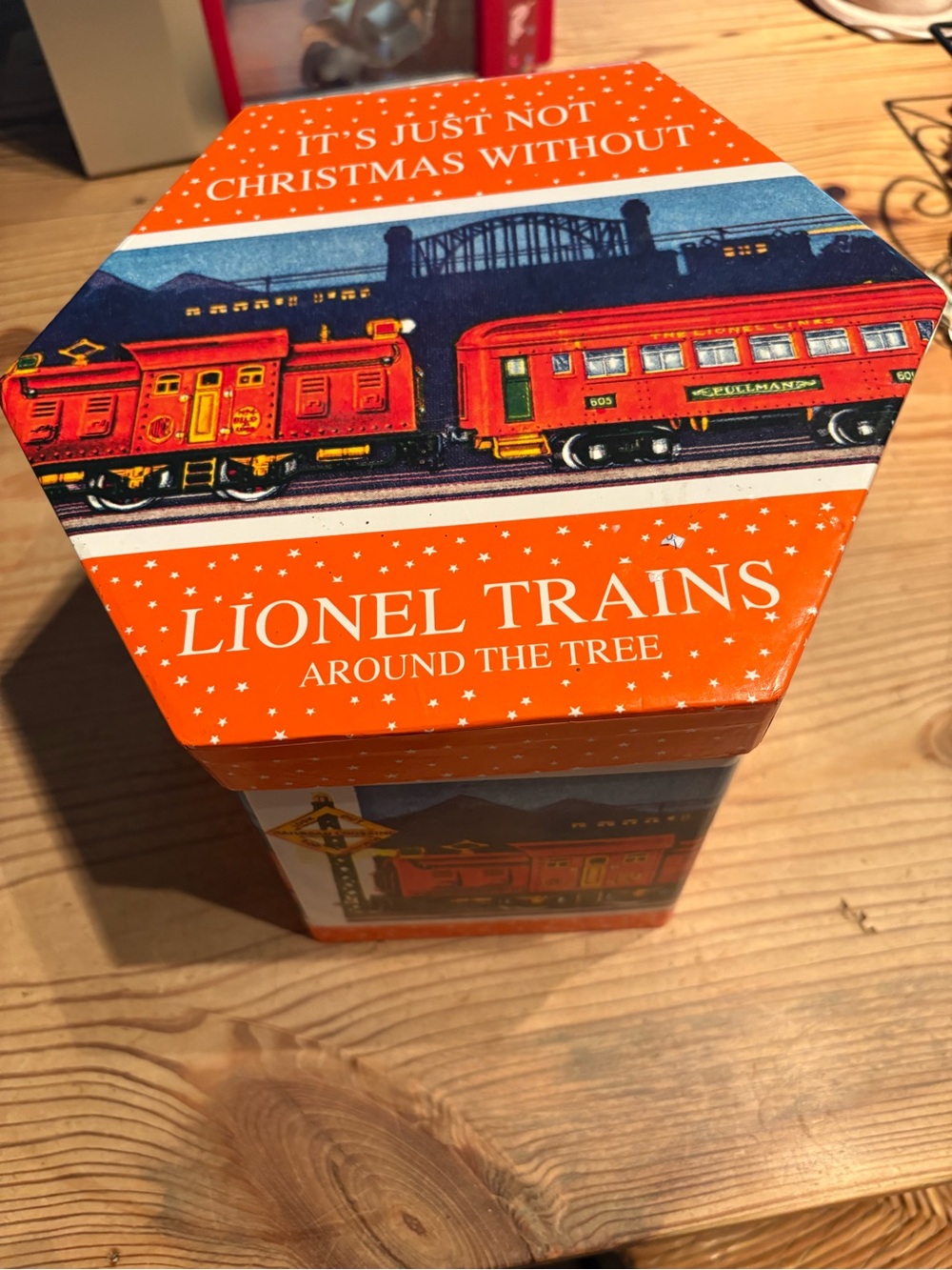 Lionel Trains Decorative Orange Holiday Tin full of ornaments.